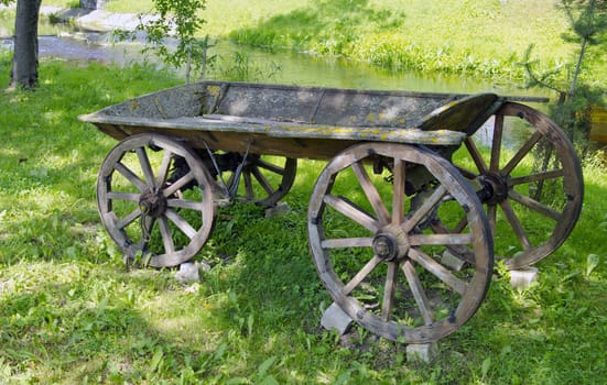 historical and aged wooden carriage in rural park