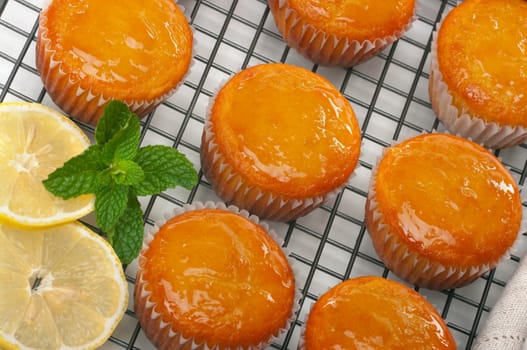 Citrus cupcakes with lemon glaze on cooling rack