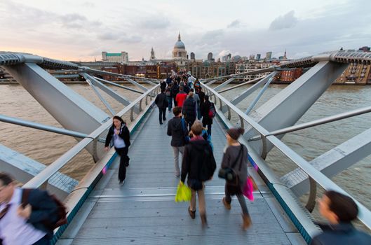 View of St. Paul's Cathedral across the pedestrian Millennium Bridge over the Thames. Shooting point higher than a man