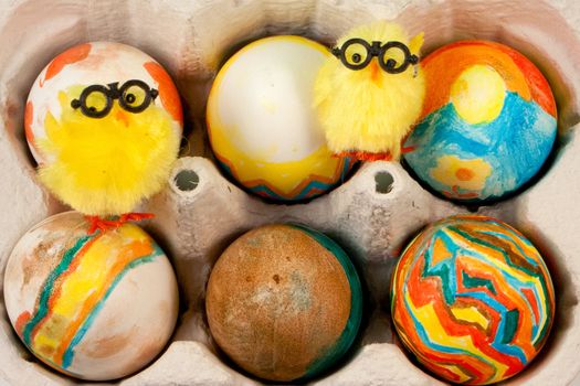 Handmade Painted Easter Eggs in eggshelf with yellow chick