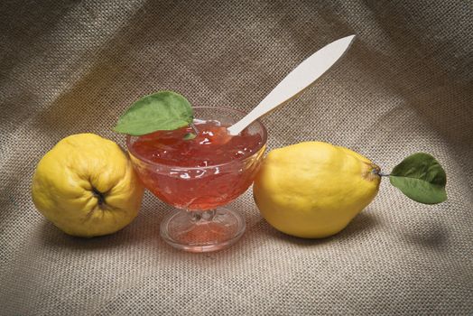 Still life with quinces and quince jelly in a glass cup