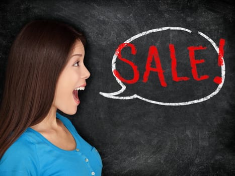 Sale blackboard woman concept. Young woman saying SALE in speech bubble on blackboard background texture. Beautiful mixed race shopper excited.
