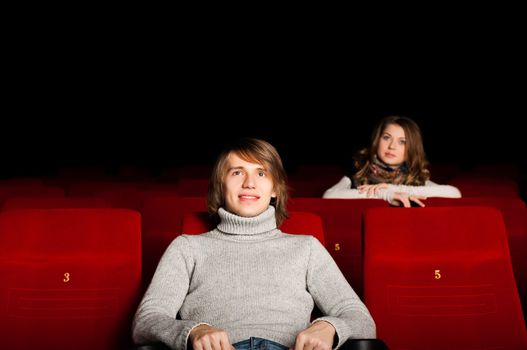 young man and woman in the cinema to enjoy the movie