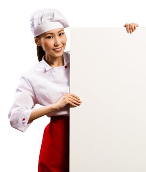 female chef holding a poster for text, look at the camera and smiling