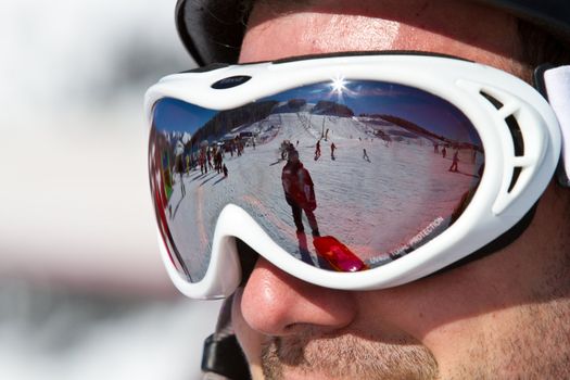 The man in the mountain-skiing form in a helmet and glasses