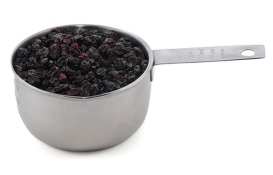 Currants presented in an American metal cup measure, isolated on a white background