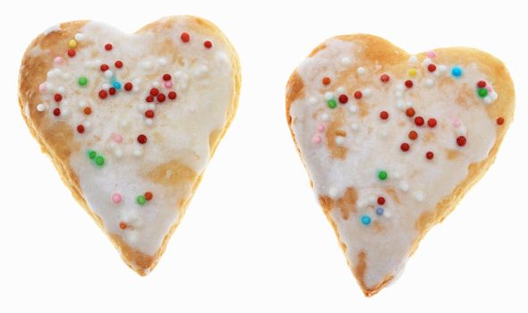 Two heart-shaped cookies isolated against a white background.