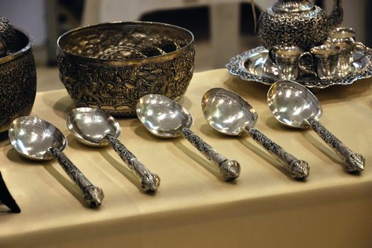 Silver Spoon is carved on the handle. At art exhibition.
