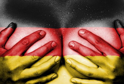 Sweaty upper part of female body, hands covering breasts, flag of Germany