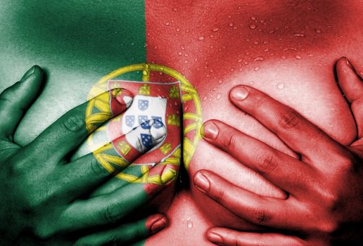 Sweaty upper part of female body, hands covering breasts, flag of Portugal
