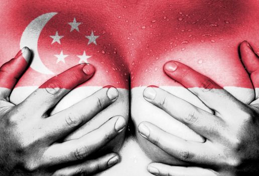 Sweaty upper part of female body, hands covering breasts, flag of Singapore