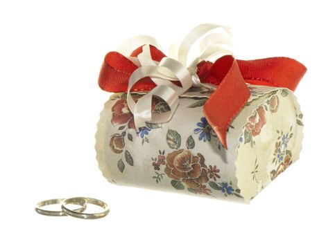 wedding favors and wedding rings on white background