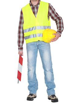 builder standing hard hat in hand wearing safety jacket