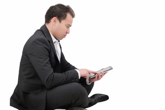 Young man sitting on a floor and using tablet pc