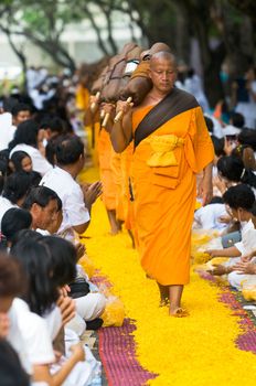 PATHUM THANI - JANUARY 27: The first of 1,128 Buddhist monks wandering 460km through Bangkok and surroundings on yellow petals on January 27, 2013 in Pathum Thani, Thailand.