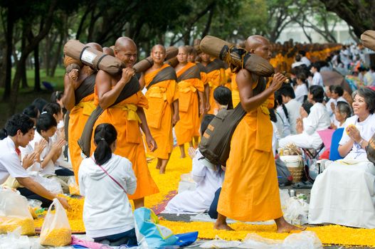 PATHUM THANI - JANUARY 27: 1,128 Buddhist monks wandering 460km through Bangkok and surroundings on yellow petals on January 27, 2013 in Pathum Thani, Thailand.