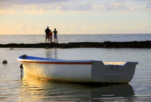 Boat near the beach at sunset. Mauritius