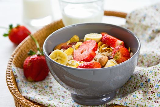 Muesli breakfast with fresh strawberry, almond, cranberries and banana