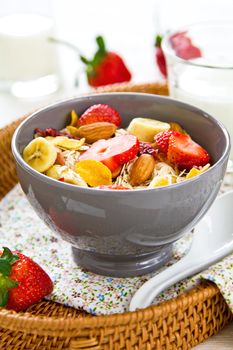 Muesli breakfast with fresh strawberry, almond, cranberries and banana
