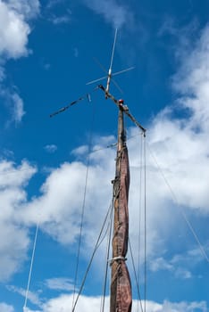 Foresail, Jib, and Wooden Mast of a sailing yacht vertical perspective boating background