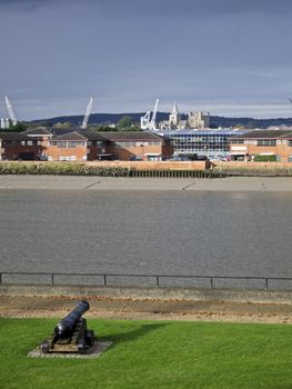 Cannon pointing across the river Medway towards Rochester castle and cathedral