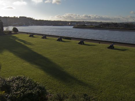 A row of cannons on the bank of the river Medway