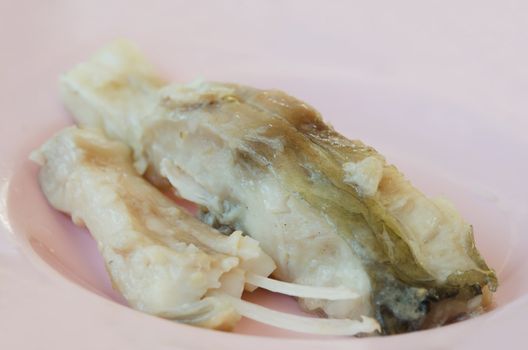 close up fresh steam fish on pink dish