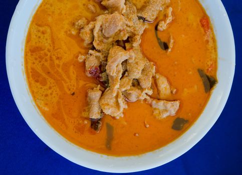  top view pork in ground peanut-coconut cream curry  on blue background