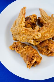 top view deep fried  chicken  on dish , blue background