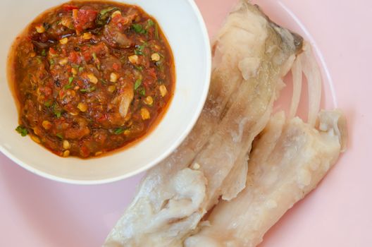 top view chili sauce and  fresh steam fish on pink dish
