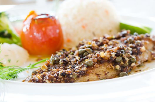 fish steak served with fried rice and vegetable