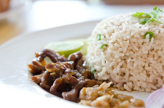 Mixed cooked rice with pork sauce and fresh vegetable , Thai favorite food of rice