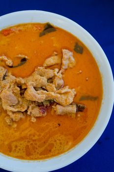  top view pork in ground peanut-coconut cream curry  on  blue background