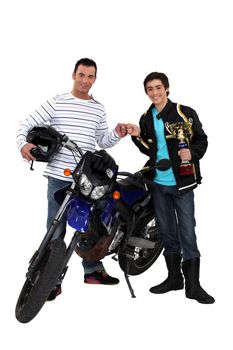 Men with motorbike and gold cup
