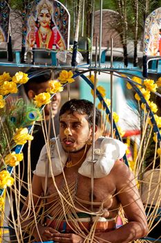 SINGAPORE – 2013 JANUARY 27: Devotee carrying a kavadi at Thaipusam taken on January 27, 2013 in Singapore. Hindu festival to worship and to make offerings to god Muruga. EDITORIAL USE ONLY!! 