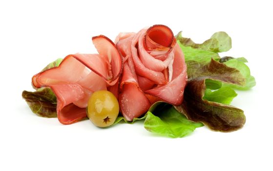 Curling Slices of Jamon on Lettuce Romano with Green Olive isolated on white background