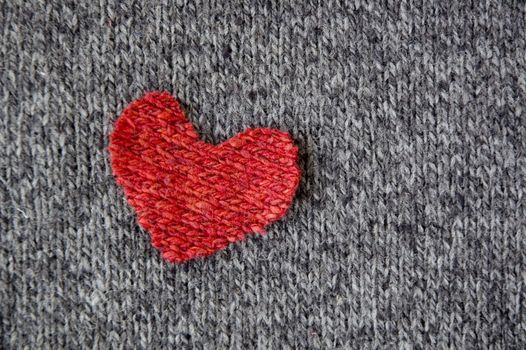 red heart on dark fabric