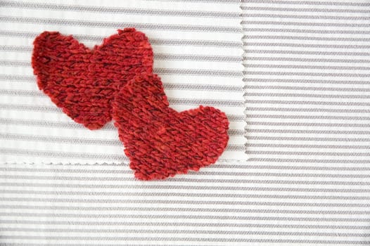 two red hearts on striped white fabric