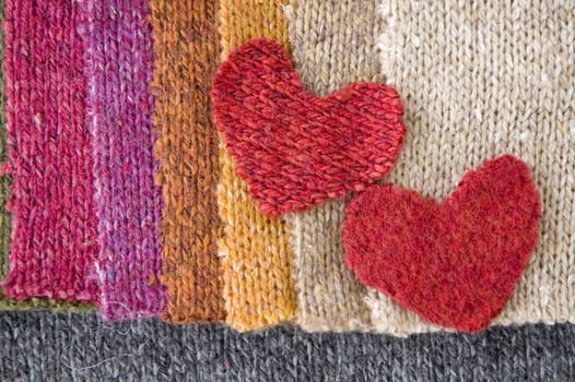 two red hearts on colorful fabric