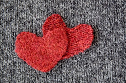 two red hearts put on dark fabric