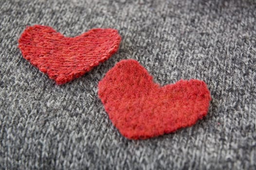 two red hearts on dark fabric