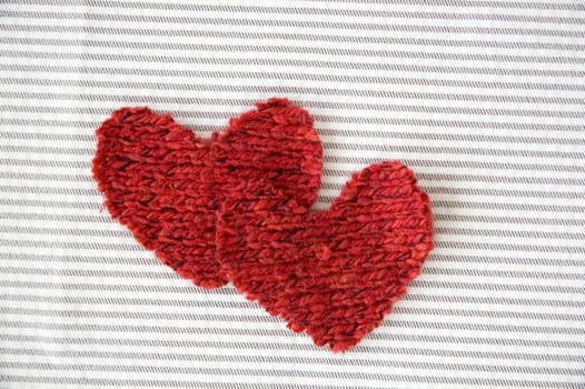 two red hearts on striped background