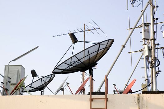 many kinds of satellite dish on top of building
