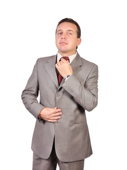 businessman adjusts his tie on white background