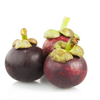 Three mangosteen isolated on a white background