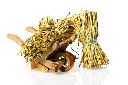 Handcart with straw on a white background