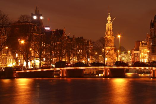 Amsterdam by night with the Munt tower in the Netherlands