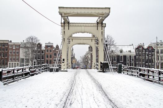 Snowy thiny bridge in Amsterdam the Netherlands in winter