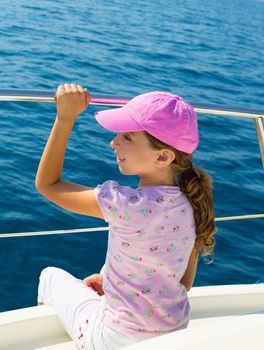 child happy girl sailing happy boat with cap at blue sea ocean