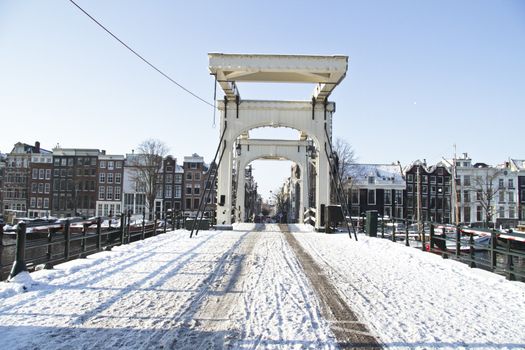 Snowy thiny bridge in Amsterdam the Netherlands in winter